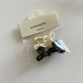 Detailed packaging view of 4 mini bow hair clips in black and beige plastic finish - Bowknot Black and White