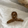 Translucent amber jelly claw clip in geometric twist design on a minimalist background - Coffee (Mini Cross)