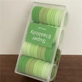 Set of gradient green elastic hair ties in a transparent acrylic storage box - Green System