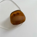Elegant amber-colored geometric hair claw clip in translucent resin with metallic spring - Large Oval / Amber