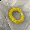 Velvet scrunchie in bright yellow with a white decorative bead on a white paper background - Bright Yellow