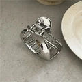 Close-up of polished silver alloy hair claw clip with geometric lines on a stone surface - Bright Silver