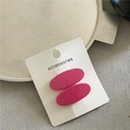 Detail of pink oval resin hair clips on a white display card with glossy smooth texture - Rose Red
