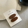 Close-up of dual dark coffee oval hair clips on an accessories display card - Coffee