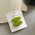 Detail of two oval grass green hair clips on an accessories display card - Light Green