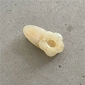 Detail of a pale yellow floral hair clip with a smooth cream-like resin finish - Beige Flower