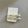 Detail view of twisted marble acetate hair clips in pastel tones on a white card - Twisted Clips / Teal