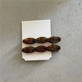 Detail view of acetate twist hair clips with tortoiseshell pattern on display card - Twisted Clips / Glazed Multi-color