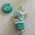 Primer plano de gomas elásticas de colores en un creativo envase de taza transparente - Verde (Serie de Hielo de Menta)