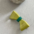 Detailed macro view of yellow jelly texture acetate bow clip with green center detail - Mustard Green