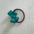 Detail shot of a dark green acetate bow hair tie with a textured brown elastic cord - 3D Bow / Dark Green