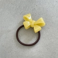 Elastic hair tie with a bright yellow acetate bow on a minimalist gray background - 3D Bow / Pale Yellow