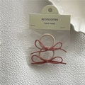Detailansicht von 2er-Pack rosa Haargummis mit Wildleder-Schleifen in Verpackung - Rosa