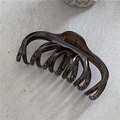 Detail view of a 13cm jelly textured amber hair claw clip on a stone surface - Translucent Black Gray