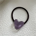 Close-up of heart hair tie featuring a purple resin heart charm on black elastic band - Purple