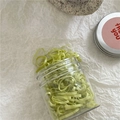 Close-up of light green high-elastic rubber hair bands in a clear plastic storage jar - 180 Pieces/Pack / Bean Green