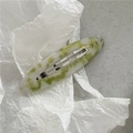 Detail view of oval acetate hair clip featuring green and white marble textures - Oval BB Clip / Green