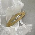 Detail view of yellow amber marble acetate hair clip with FRANCE Handmade engraving - Oval BB Clip / Khaki