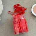 Detailed view of red elastic rubber bands in a transparent jar on a stone texture background - 180 Pieces/Pack / Red