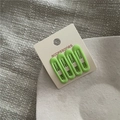 Close-up of 4-piece matte green oval hair clips set on white branded cardstock - H6.2 Grass Green (four Round-headed Baby Clips) J181-b7