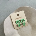 Close-up of two mint green hollow star hair clips on white backing card in a ceramic dish - A3.2 Light Mint Green (star Clip) Jx-b187