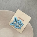 Close-up of two light blue butterfly hair clips on a white display card for kids - Blue
