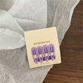 Detailed view of four purple teardrop hair clips displayed on a handmade paper card - Purple