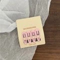 Close-up of 4-piece pink lacquer drop hair clips on handmade card display - Pink