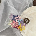 Detailed view of colorful star-shaped hair clips in branded handmade packaging bag - Pentagram