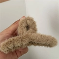 Close-up of soft khaki plush hair claw clip showing fuzzy texture and sturdy spring mechanism - Light Coffee