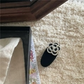Dettaglio dell'elegante fermaglio per capelli a camelia con perle e velluto - Nero Floreale