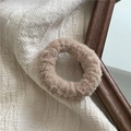 Detailed view of plush cream faux fur hair scrunchie with soft curly texture on fabric - Khaki