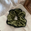 Detail of dark green velvet scrunchie with black faux fur trim on a beige background - Dark Green