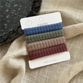 Set of four soft corduroy elastic hair ties in retro colors on a white display card - Blue Green Purple