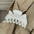 Close-up of white plush velvet hair claw clip on beige linen fabric texture - White Flocked Butterfly Hair Claw (F7.5 -A)