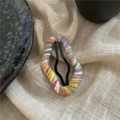 Detailed view of handmade colorful yarn-wrapped cloud BB hair clip on soft cotton fabric - Gray Purple White