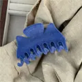 Detail of blue flocked claw clip showing plush texture on soft beige linen background - Blue Flocked Butterfly Hair Claw (G7.5 -A)