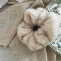 Close-up of luxury plush faux mink scrunchie with soft fluffy texture and striped pattern - Off White