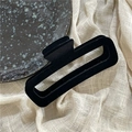 Detailed view of rectangle black velvet hair claw clip on soft beige textured linen cloth - Black Rectangle