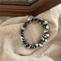 Close-up of black and white woven tweed elastic hair ring with soft texture details - Black and White