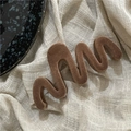 Detail of coffee-colored flocked wave hair claw on aesthetic linen background - Coffee Wave
