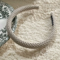 Beige chunky knit sponge headband with handmade label on soft plush background - Beige