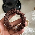 Detailed view of dark brown scrunchie with a vintage leopard print amber bead decoration - Coffee (Leopard Bead)