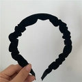Close-up of black velvet pleated headband showing soft texture and elegant vintage style - Black