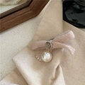 Close-up of pink knit bow hair clip with silver charm and white faux pearl detail - Woolen Bow Duckbill Clip / Off White