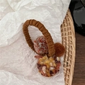 Detailed close-up of brown elastic hair tie with colorful knit plush balls on white paper - Brown