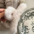 Detail shot of fluffy cream faux fur hair claw clip with soft texture and internal spring - Off White