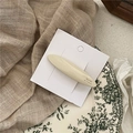 Detail of cream acetate barrette on display card featuring Barrette La France text - Cream White