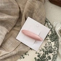 Detail of a pearlescent pink acetate hair clip displayed on a minimalist white card - Pink