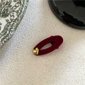 Close-up of red flocked oval hair clip featuring a gold heart accent and velvet texture - Wine Red Heart